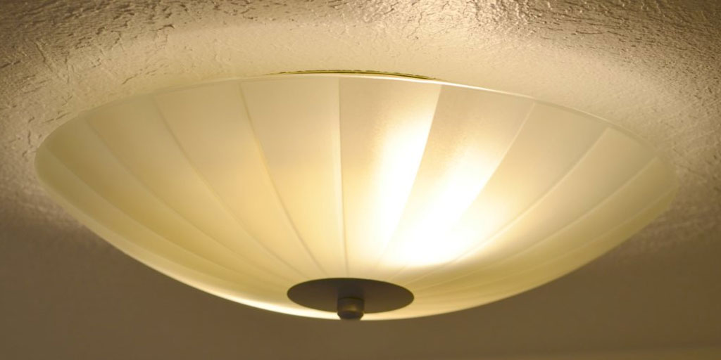 brown glass enclosed kitchen light fixture